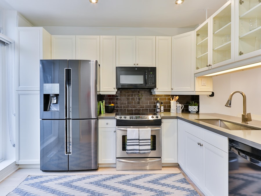 A bright white kitchen with a stainless fridge, range, microwave and dishwasher.