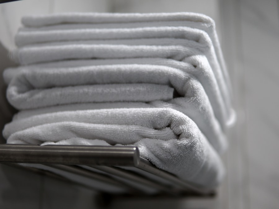 A stack of clean white towels folded on a rail.